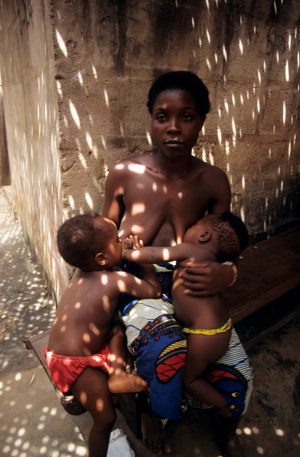 Matka (otrokyně fetiše) se dvěma dětmi před jejich domovem v ghanské provincii Volo, Ghana