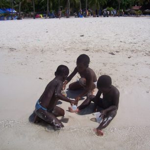 Děti na bělostné pláži v Boca Chica, Dominikánská republika