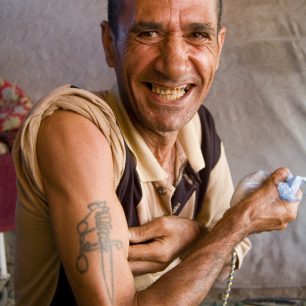 Muž předvádí své tetování