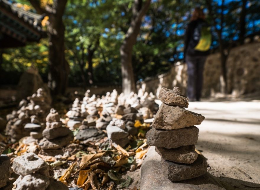 Malé mohylky z kamínků Korejci s oblibou staví u lesních chrámů, Odaesan, Jižní Korea